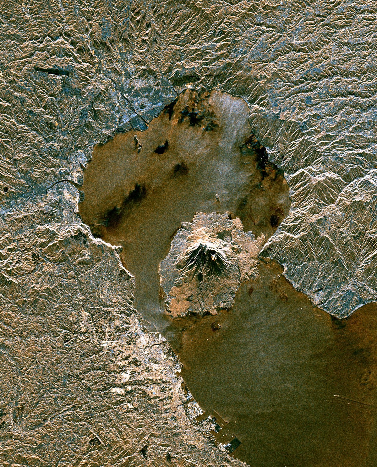  Sakura-Jima volcano, Kyushu, Japan The enormous amounts of energy slumbering inside our planet burst to the surface at the edges of the continental plates and at the cracks in the earth’s crust. This satellite radar photograph shows the relatively young Sakura-Jima volcano that erupted on a peninsula in the bay of Kagoshima and has been continually active since 1955.